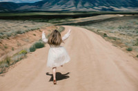 Child skipping down road in Wyoming